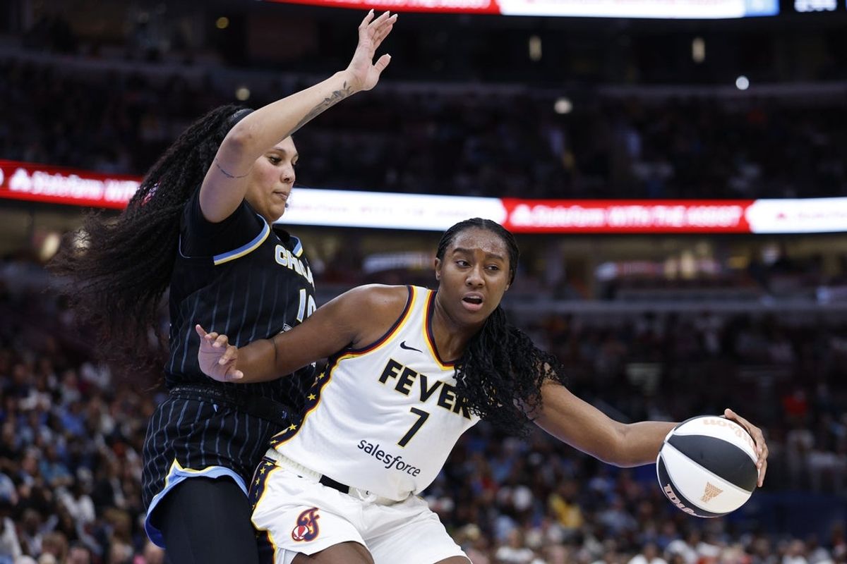 Jun 7, 2025; Chicago, Illinois, USA; Indiana Fever forward Aliyah Boston (7) drives to the basket against Chicago Sky center Kamilla Cardoso (10) during the first half of a WNBA game at United Center. Mandatory Credit: Kamil Krzaczynski-Imagn Images