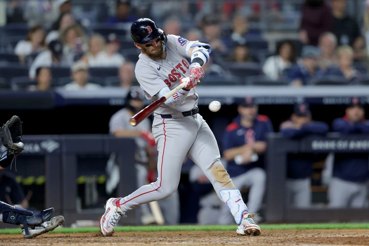 Jun 7, 2025; Bronx, New York, USA; Boston Red Sox shortstop Trevor Story (10) hits a two run single against the New York Yankees during the ninth inning at Yankee Stadium. Mandatory Credit: Brad Penner-Imagn Images