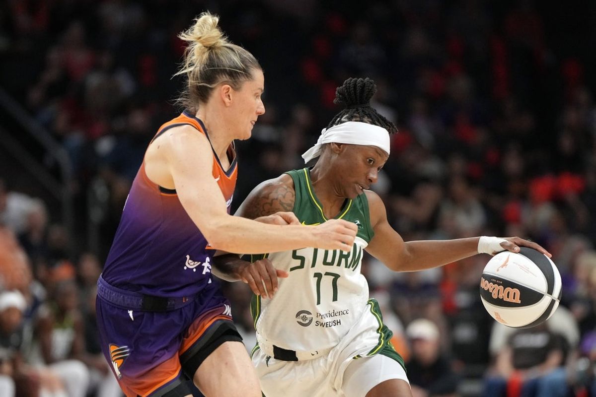 Jun 7, 2025; Phoenix, Arizona, USA; Seattle Storm guard Erica Wheeler (17) drives against Phoenix Mercury guard Sami Whitcomb (33) in the first half at Footprint Center. Mandatory Credit: Rick Scuteri-Imagn Images