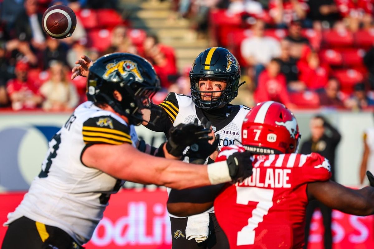 Jun 7, 2025; Calgary, Alberta, Canada; Hamilton Tiger-Cats quarterback Bo Levi Mitchell (19) throws a pass against the Calgary Stampeders during the second half at McMahon Stadium. Mandatory Credit: Sergei Belski-Imagn Images