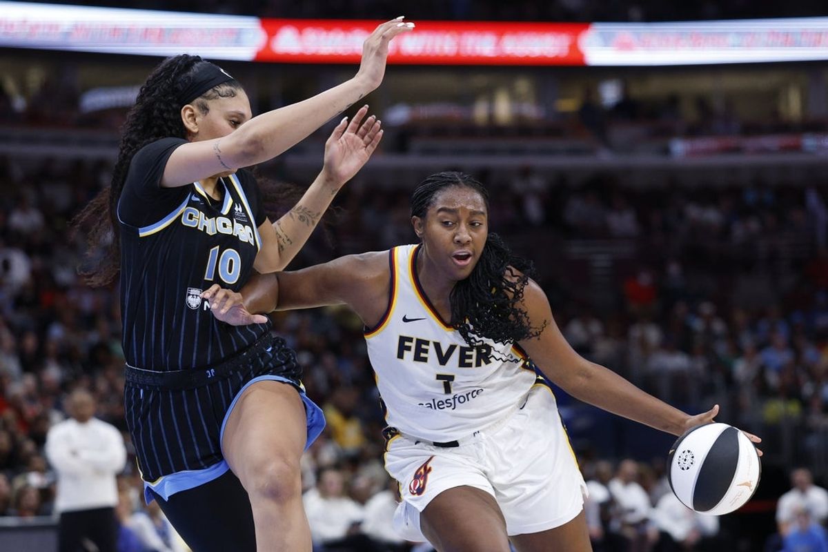 Jun 7, 2025; Chicago, Illinois, USA; Indiana Fever forward Aliyah Boston (7) drives to the basket against Chicago Sky center Kamilla Cardoso (10) during the first half of a WNBA game at United Center. Mandatory Credit: Kamil Krzaczynski-Imagn Images