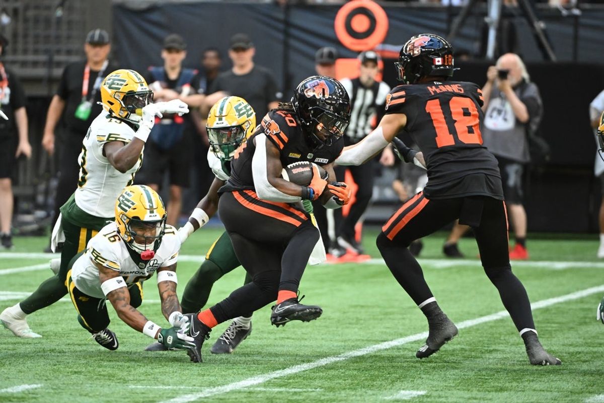 Jun 7, 2025; Vancouver, British Columbia, Canada;   BC Lions running back James  Butler (20) runs the ball defended by Edmonton Elks defensive back Devodric Bynum (16) during the first half at BC Place Stadium. Mandatory Credit: Anne-Marie Sorvin-Imagn Images