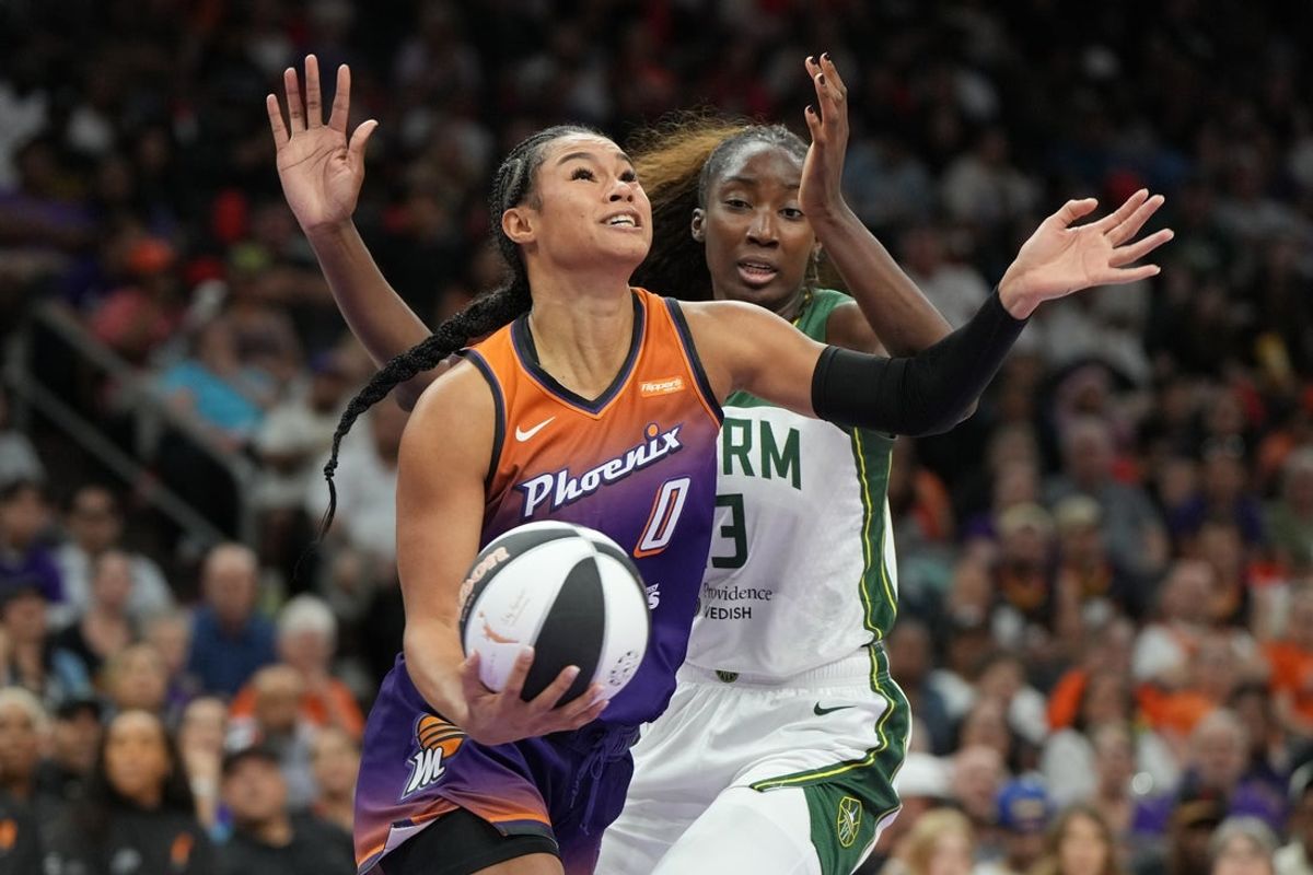 Jun 7, 2025; Phoenix, Arizona, USA; Phoenix Mercury forward Satou Sabally (0) drives on Seattle Storm forward Ezi Magbegor (13) in the second half at Footprint Center. Mandatory Credit: Rick Scuteri-Imagn Images