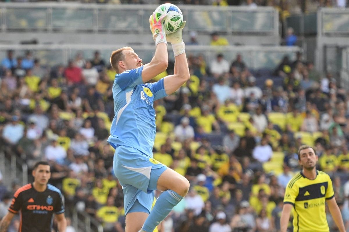 May 31, 2025; Nashville, Tennessee, USA;  Nashville SC goalkeeper Joe Willis (1) makes a saves against the New York City FC during the second half at Geodis Park. Mandatory Credit: Steve Roberts-Imagn Images