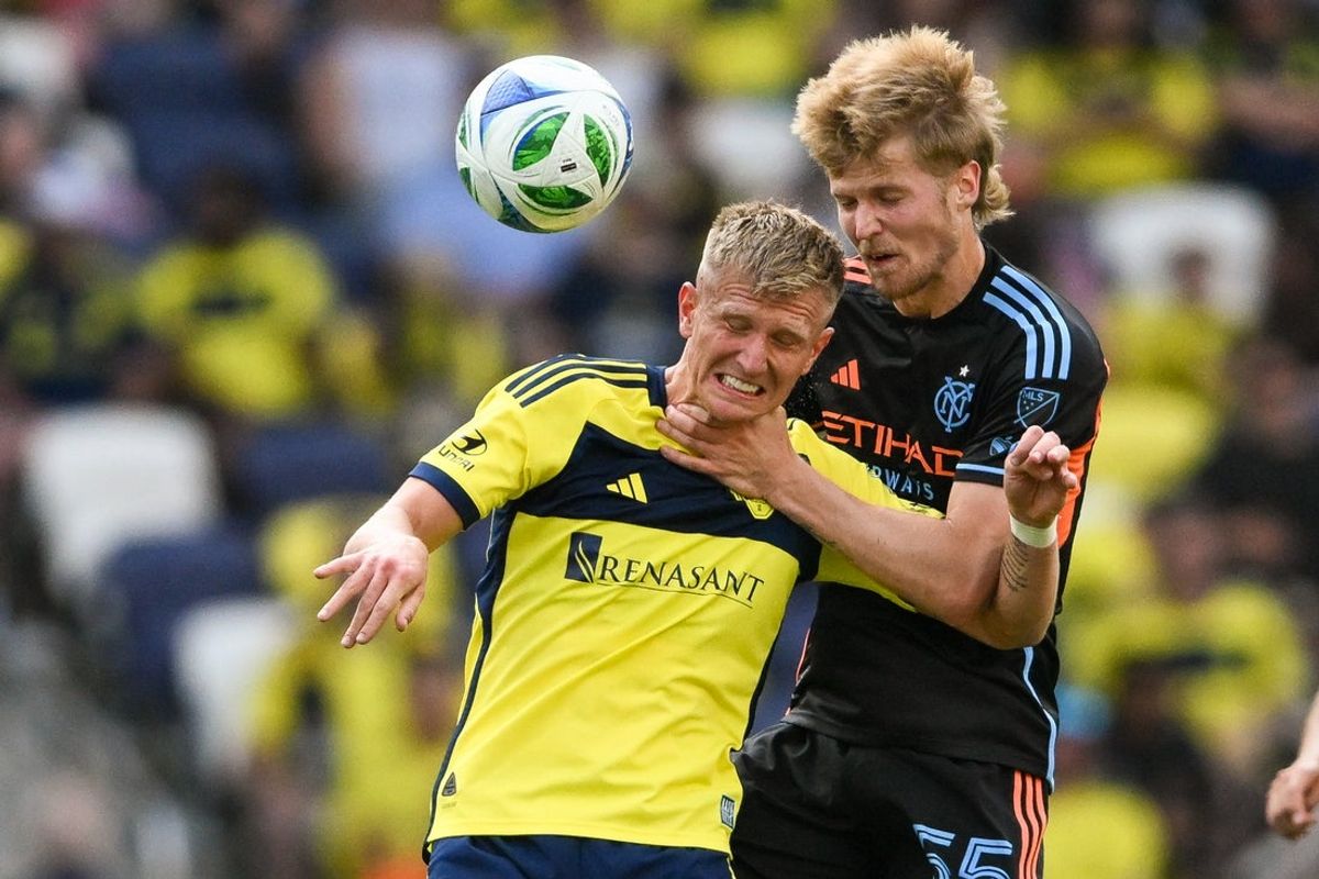 May 31, 2025; Nashville, Tennessee, USA;  Nashville SC forward Sam Surridge (9) and New York City FC midfielder Keaton Parks (55) heads the ball during the second half at Geodis Park. Mandatory Credit: Steve Roberts-Imagn Images