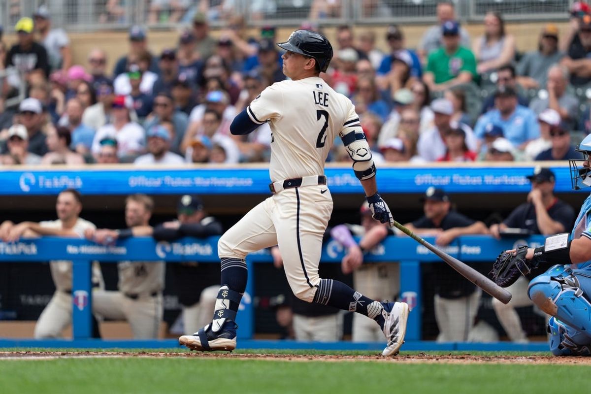 Jun 8, 2025; Minneapolis, Minnesota, USA; Minnesota Twins third baseman Brooks Lee (2) hits a single during the second inning against the Toronto Blue Jays at Target Field. Mandatory Credit: Jordan Johnson-Imagn Images