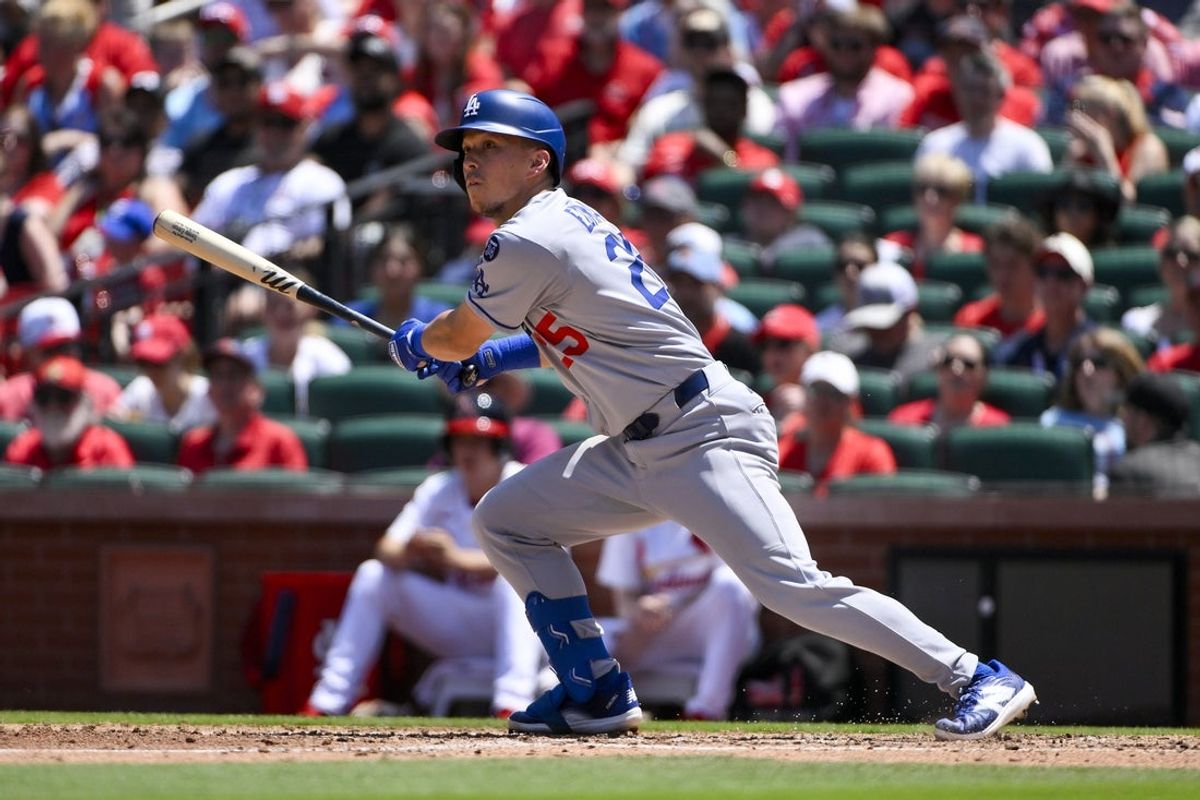 Jun 8, 2025; St. Louis, Missouri, USA;  Los Angeles Dodgers second baseman Tommy Edman (25) hits a one run double against the St. Louis Cardinals during the fourth inning at Busch Stadium. Mandatory Credit: Jeff Curry-Imagn Images