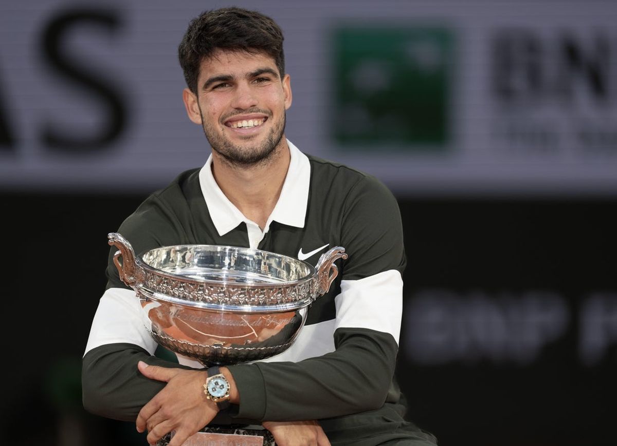 Jun 8, 2025; Paris, FR; Carlos Alcaraz of Spain poses with the trophy after winning the men’s singles final against Jannik Sinner of Italy on day 15 at Roland Garros Stadium. Mandatory Credit: Susan Mullane-Imagn Images