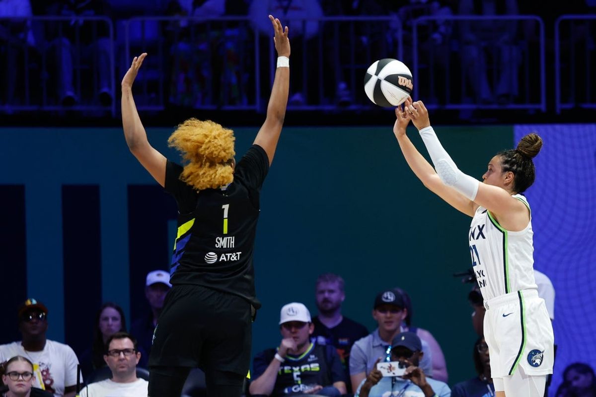 Jun 8, 2025; Arlington, Texas, USA; Minnesota Lynx guard Kayla McBride (21) scores a three point basket against Dallas Wings forward NaLyssa Smith (1) during the first half at College Park Center. Mandatory Credit: Chris Jones-Imagn Images