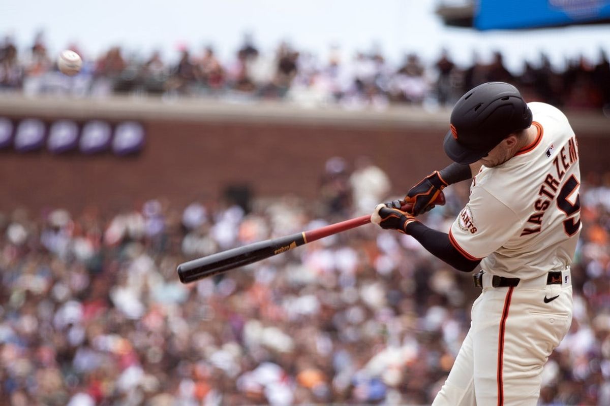 Jun 8, 2025; San Francisco, California, USA; San Francisco Giants right fielder Mike Yastrzemski (5) connects for a sacrifice fly against the Atlanta Braves during the second inning at Oracle Park. Mandatory Credit: D. Ross Cameron-Imagn Images