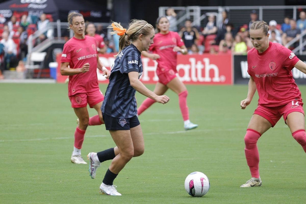 Jun 8, 2025; Washington, District of Columbia, USA; Washington Spirit forward Brittany Ratcliffe (13) controls the ball as North Carolina Courage defender Talia Staude (12) defends during the first half at Audi Field. Mandatory Credit: Amber Searls-Imagn Images