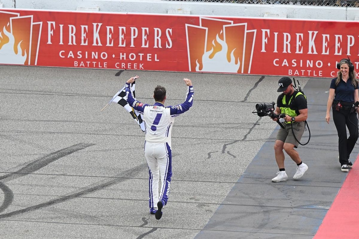 Jun 8, 2025; Brooklyn, Michigan, USA; NASCAR Cup Series driver Denny Hamlin (11) salutes the crowd after winning the FireKeepers Casino 400 at Michigan International Speedway. Mandatory Credit: Lon Horwedel-Imagn Images
