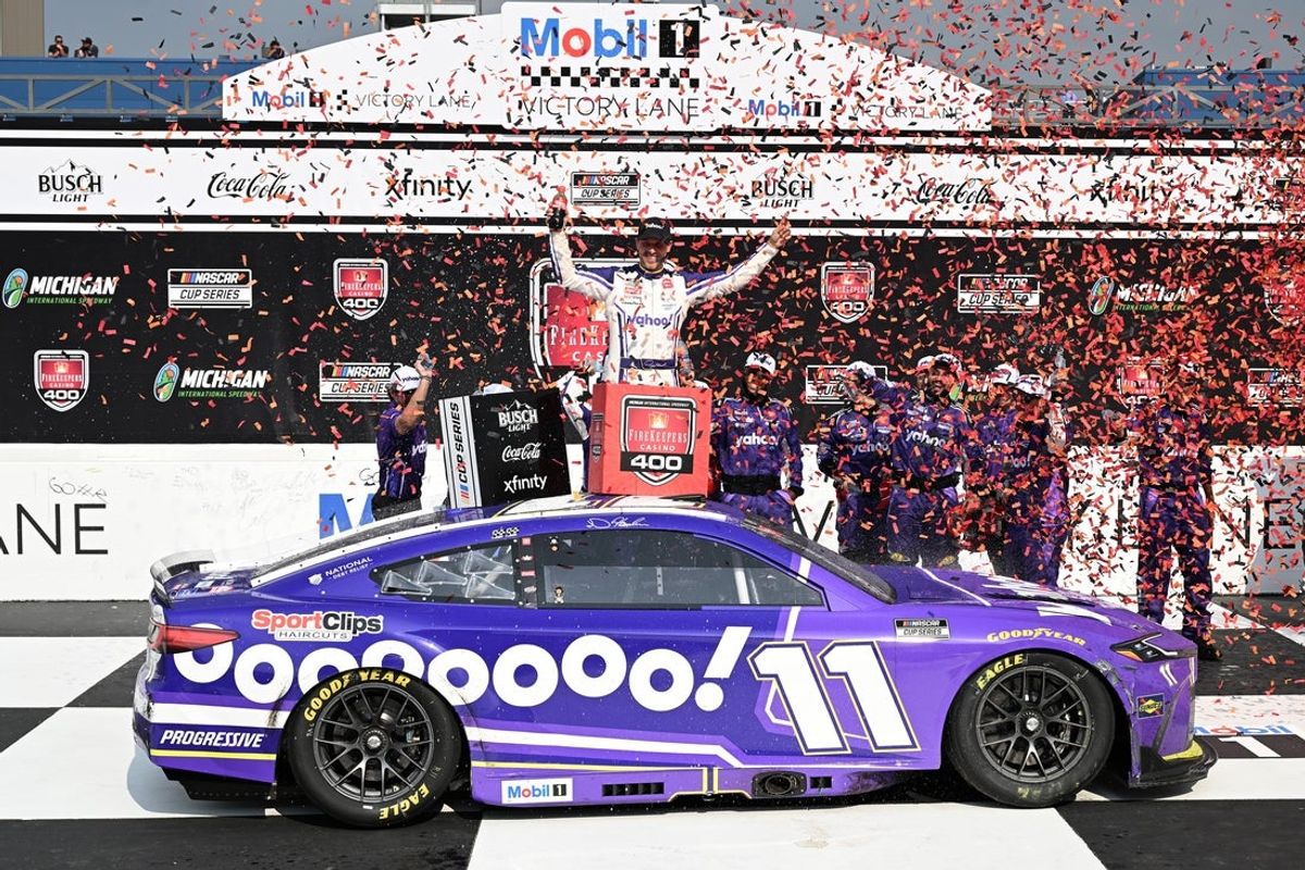 Jun 8, 2025; Brooklyn, Michigan, USA; NASCAR Cup Series driver Denny Hamlin (11) celebrates with his team after winning the FireKeepers Casino 400 at Michigan International Speedway. Mandatory Credit: Lon Horwedel-Imagn Images