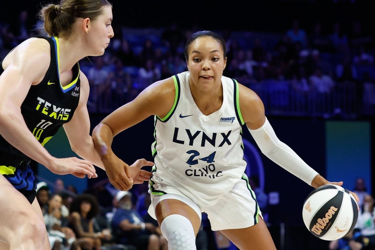 Jun 8, 2025; Arlington, Texas, USA; Minnesota Lynx forward Napheesa Collier (24) controls the ball as Dallas Wings center Luisa Geiselsoder (18) defends during the second half at College Park Center. Mandatory Credit: Chris Jones-Imagn Images