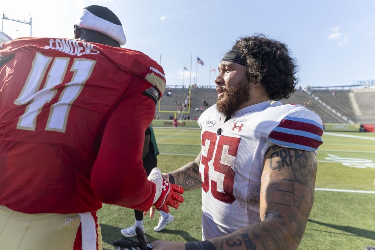 Jun 8, 2025; Birmingham, AL, USA; Birmingham Stallions defensive lineman Myjai Sanders (41) and Michigan Panthers running back Toa Taua (35) shake hands after the USFL conference championship football game at Protective Stadium. Mandatory Credit: Vasha Hunt-Imagn Images
