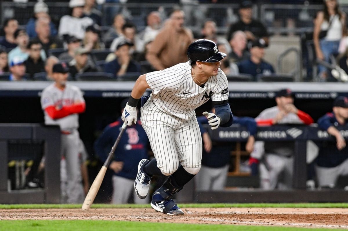 Jun 8, 2025; Bronx, New York, USA; New York Yankees shortstop Anthony Volpe (11) hits an infield single against the Boston Red Sox during the sixth inning at Yankee Stadium. Mandatory Credit: John Jones-Imagn Images