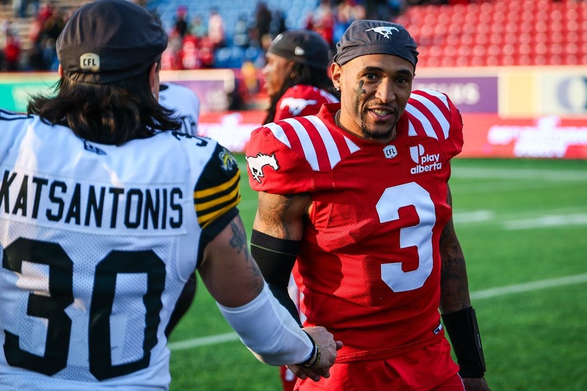 Jun 7, 2025; Calgary, Alberta, Canada; Calgary Stampeders quarterback Vernon Adams Jr (3) shakes hands with Hamilton Tiger-Cats defensive back Stavros Katsantonis (30) after the game at McMahon Stadium. Mandatory Credit: Sergei Belski-Imagn Images