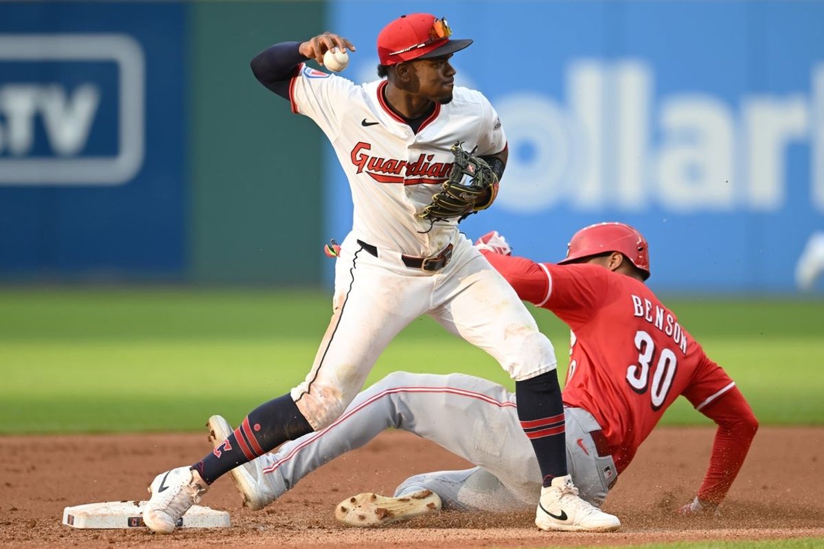 Jun 9, 2025; Cleveland, Ohio, USA; Cleveland Guardians second baseman Angel Martinez (1) forces out Cincinnati Reds left fielder Will Benson (30) and turns the double play during the fourth inning at Progressive Field. Mandatory Credit: Ken Blaze-Imagn Images