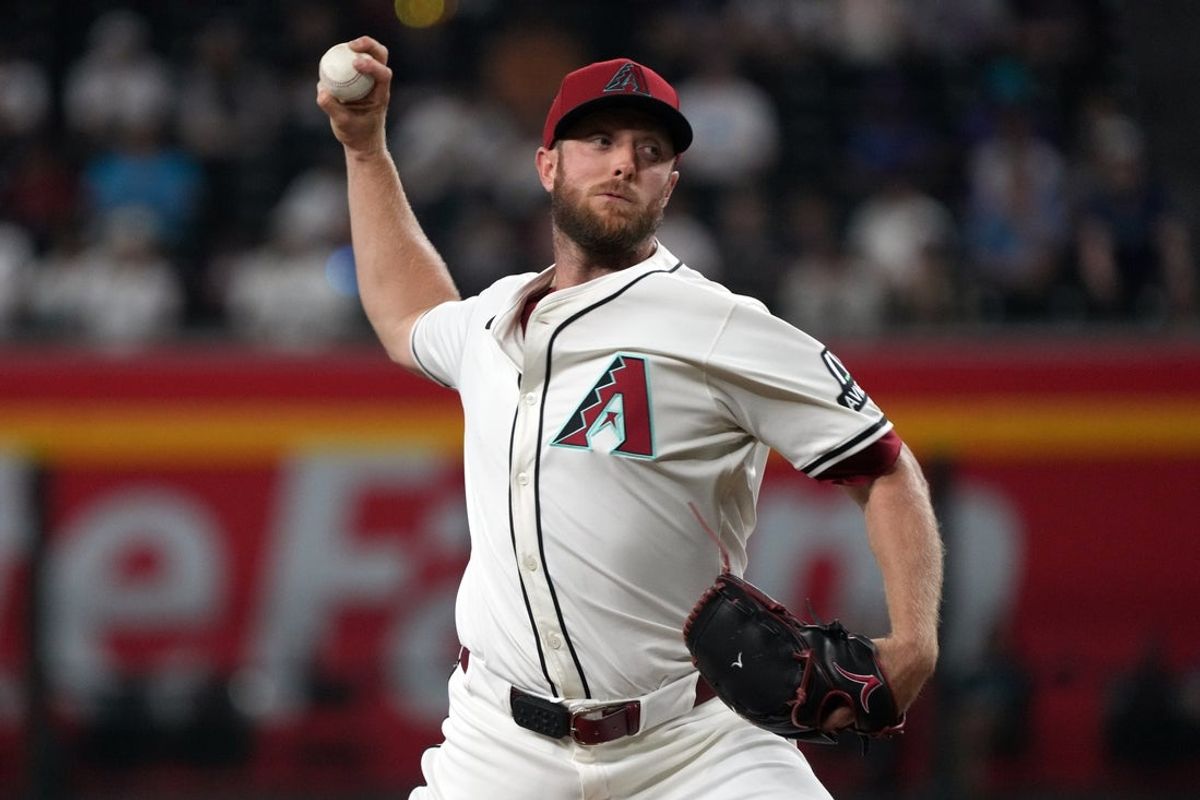 Jun 9, 2025; Phoenix, Arizona, USA; Arizona Diamondbacks pitcher Merrill Kelly (29) throws against the Seattle Mariners in the first inning at Chase Field. Mandatory Credit: Rick Scuteri-Imagn Images