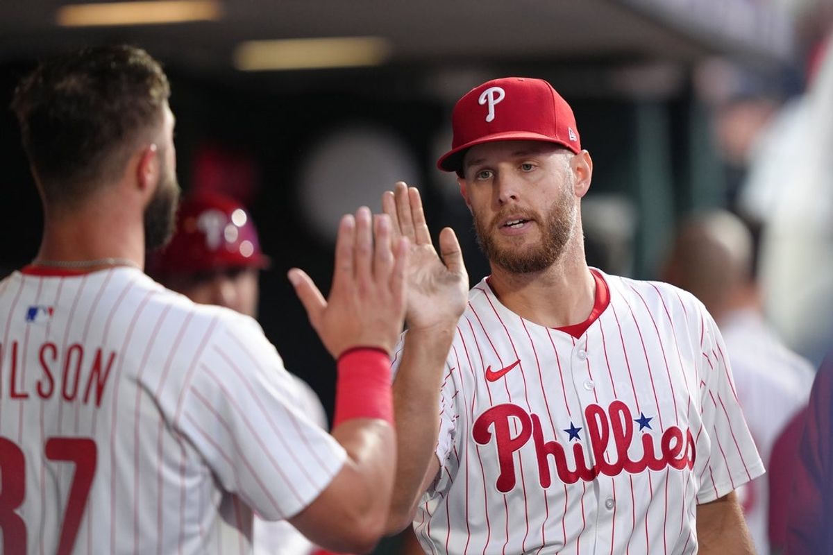 Jun 9, 2025; Philadelphia, Pennsylvania, USA; Philadelphia Phillies starting pitcher Zack Wheeler (45) reacts with teammates after recording his 1000th career strikeout against the Chicago Cubs in the fifth inning at Citizens Bank Park. Mandatory Credit: Kyle Ross-Imagn Images