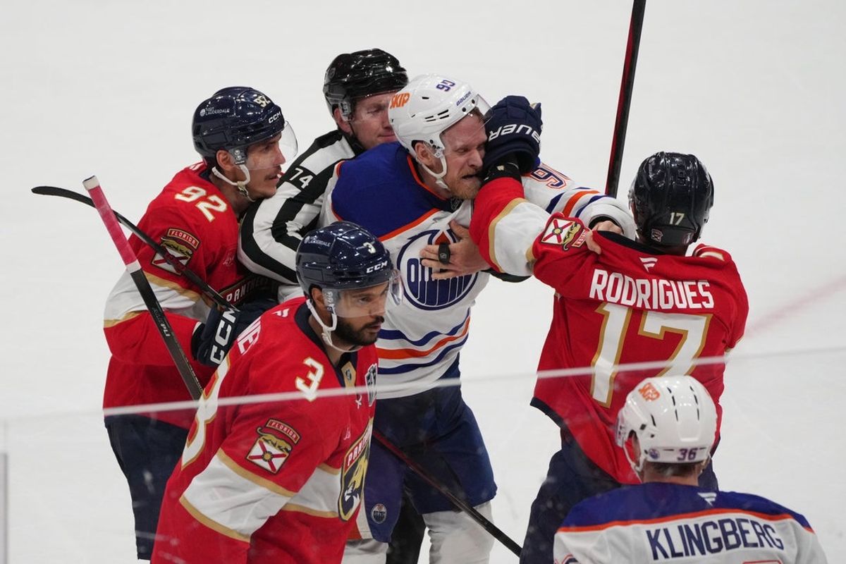 Jun 9, 2025; Sunrise, Florida, USA; Florida Panthers forward Evan Rodrigues (17) fights Edmonton Oilers right wing Corey Perry (90) during the third period in game three of the 2025 Stanley Cup Final at Amerant Bank Arena. Mandatory Credit: Jim Rassol-Imagn Images