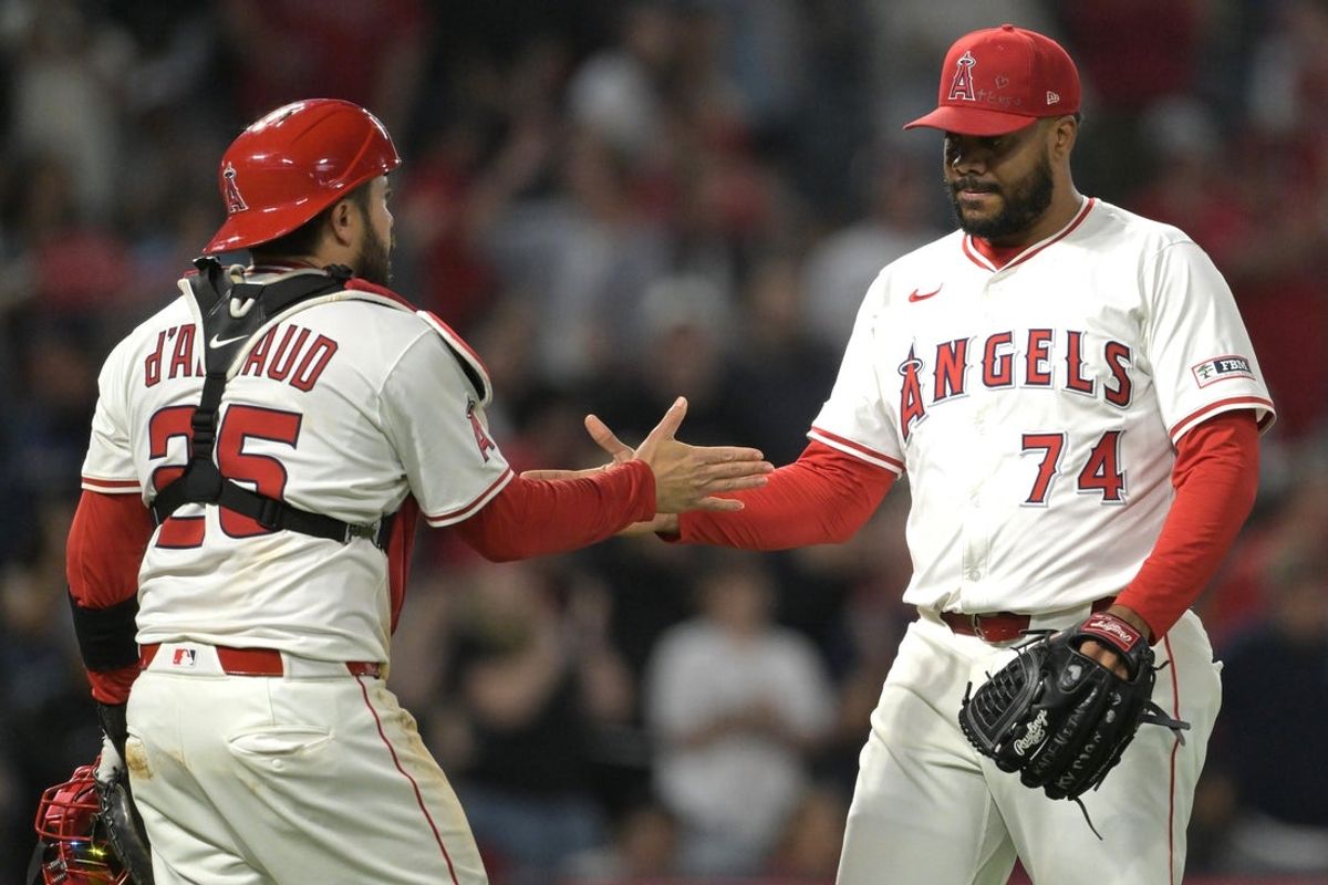 Jun 9, 2025; Anaheim, California, USA;   Los Angeles Angels relief pitcher Kenley Jansen (74) shakes hands with catcher Travis d'Arnaud (25) after his 15th save of the season in the ninth inning against the Athletics at Angel Stadium. Mandatory Credit: Jayne Kamin-Oncea-Imagn Images