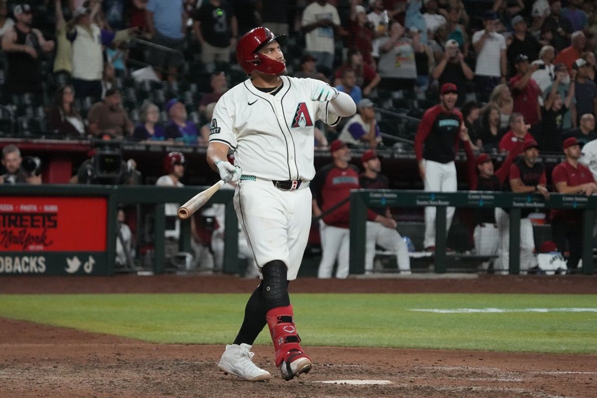 Jun 9, 2025; Phoenix, Arizona, USA; Arizona Diamondbacks first base Josh Naylor (22) hits a walk-off grand slam home run against the Seattle Mariners in the eleventh inning at Chase Field. Mandatory Credit: Rick Scuteri-Imagn Images