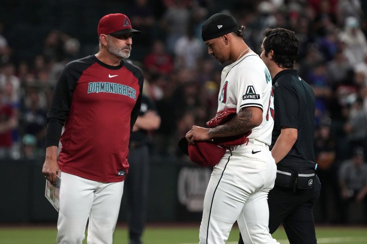 Jun 9, 2025; Phoenix, Arizona, USA; Arizona Diamondbacks pitcher Justin Martinez (63) leaves the game after an injury against the Seattle Mariners in the ninth inning at Chase Field. Mandatory Credit: Rick Scuteri-Imagn Images