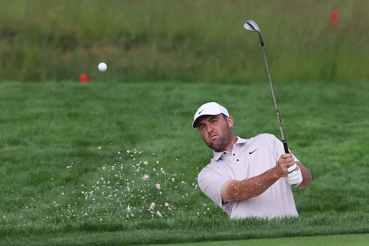 Jun 10, 2025; Oakmont, Pennsylvania, USA; Scottie Scheffler hits out of a bunker on the second hole during a practice round for the U.S. Open golf tournament at Oakmont Country Club. Mandatory Credit: Bill Streicher-Imagn Images