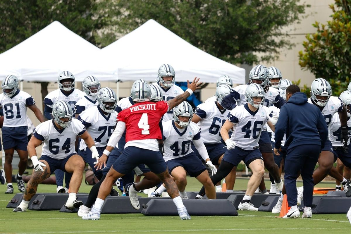 Jun 10, 2025; Arlington, TX, USA;  Dallas Cowboys quarterback Dak Prescott (4) leads teammates through a drill at the Ford Center at the Star Training Facility in Frisco, Texas. Mandatory Credit: Chris Jones-Imagn Images