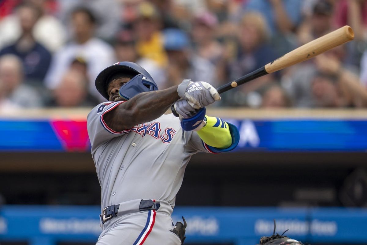 Jun 10, 2025; Minneapolis, Minnesota, USA; Texas Rangers right fielder Adolis Garcia (53) hits a single against the Minnesota Twins in the second inning at Target Field. Mandatory Credit: Jesse Johnson-Imagn Images