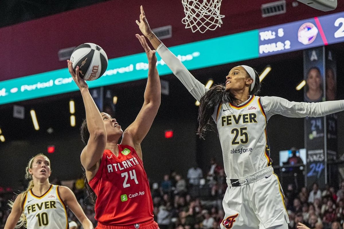 Jun 10, 2025; College Park, Georgia, USA; Atlanta Dream forward Brionna Jones (24) shoots against Indiana Fever forward DeWanna Bonner (25) during the first half at Gateway Center Arena at College Park. Mandatory Credit: Dale Zanine-Imagn Images