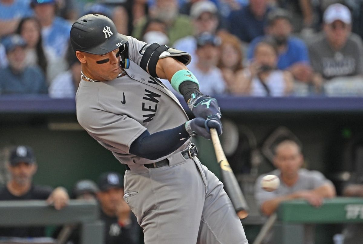 Jun 10, 2025; Kansas City, Missouri, USA;  New York Yankees designated hitter Aaron Judge (99) hits a two-run home run in the first inning against the Kansas City Royals at Kauffman Stadium. Mandatory Credit: Peter Aiken-Imagn Images