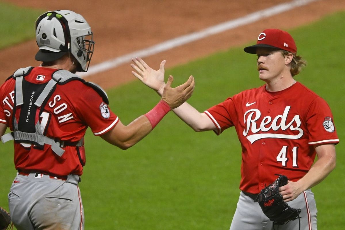 Jun 10, 2025; Cleveland, Ohio, USA; Cincinnati Reds catcher Tyler Stephenson (37) and starting pitcher Andrew Abbott (41) celebrate a win over the Cleveland Guardians at Progressive Field. Mandatory Credit: David Richard-Imagn Images