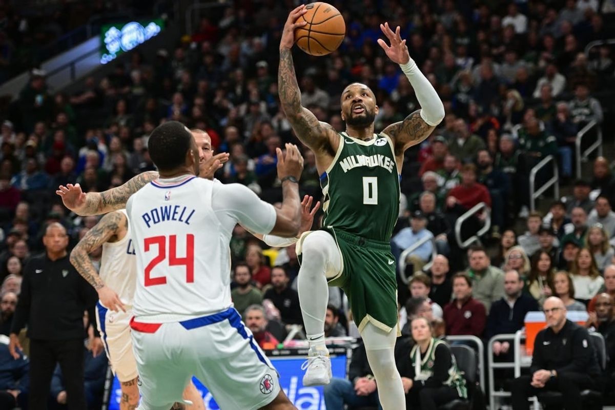 Mar 4, 2024; Milwaukee, Wisconsin, USA;  Milwaukee Bucks guard Damian Lillard (0) takes a shot against Los Angeles Clippers guard Norman Powell (24) in the third quarter at Fiserv Forum.