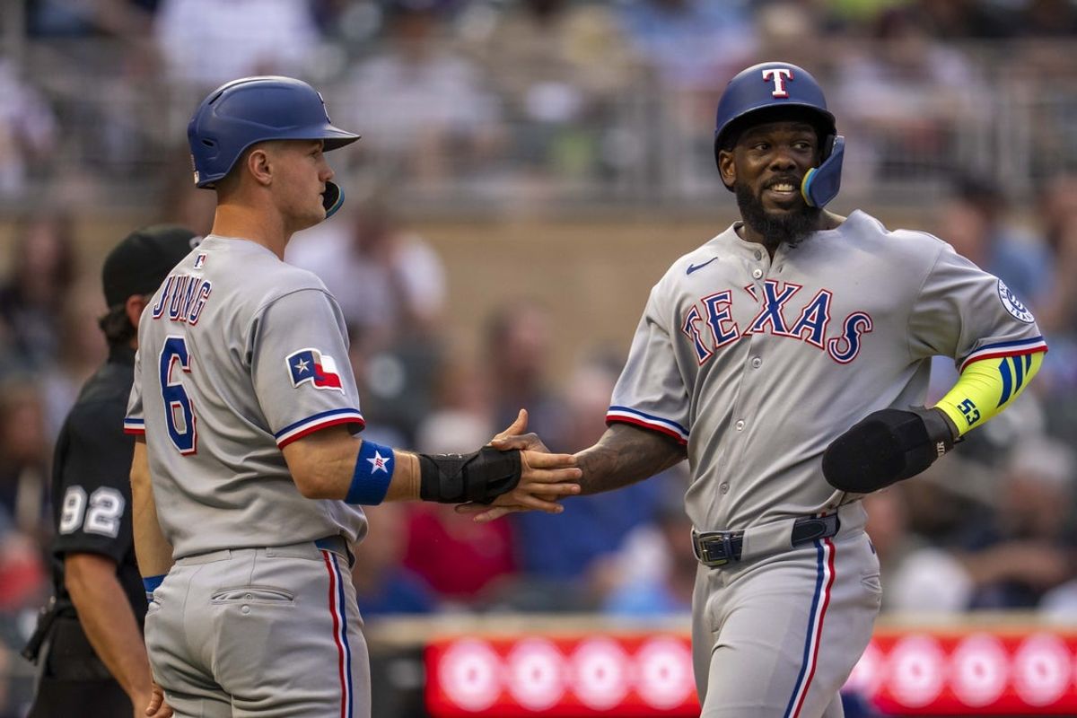 Jun 10, 2025; Minneapolis, Minnesota, USA; Texas Rangers right fielder Adolis Garcia (53) and third baseman Josh Jung (6) celebrate after scoring runs against the Minnesota Twins in the fifth inning at Target Field. Mandatory Credit: Jesse Johnson-Imagn Images