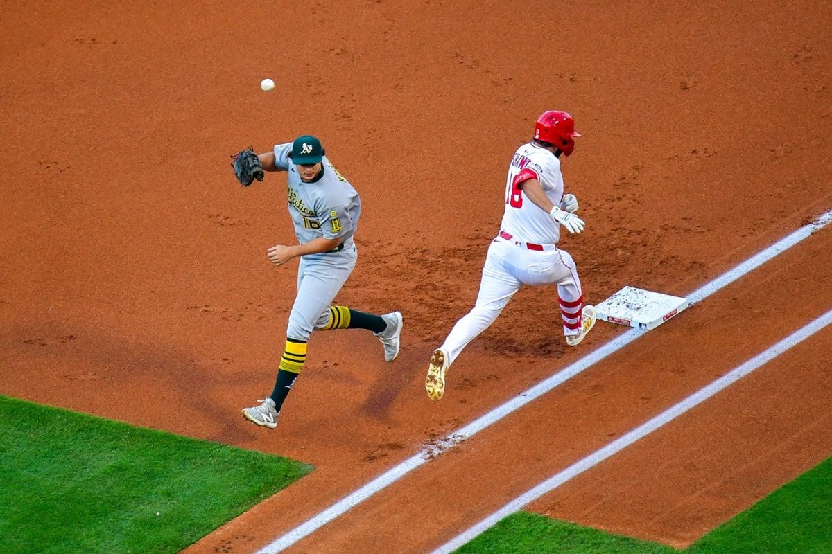 Jun 10, 2025; Anaheim, California, USA; Los Angeles Angels first baseman Nolan Schanuel (18) reaches first ahead of the throw to Athletics first baseman Nick Kurtz (16) during the first inning at Angel Stadium. Mandatory Credit: Gary A. Vasquez-Imagn Images