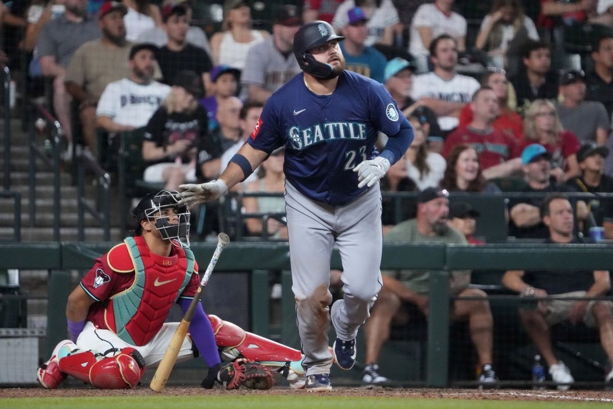 Jun 10, 2025; Phoenix, Arizona, USA; Seattle Mariners first base Rowdy Tellez (23) hirs a home run against the Arizona Diamondbacks during the sixth inning at Chase Field. Mandatory Credit: Joe Camporeale-Imagn Images