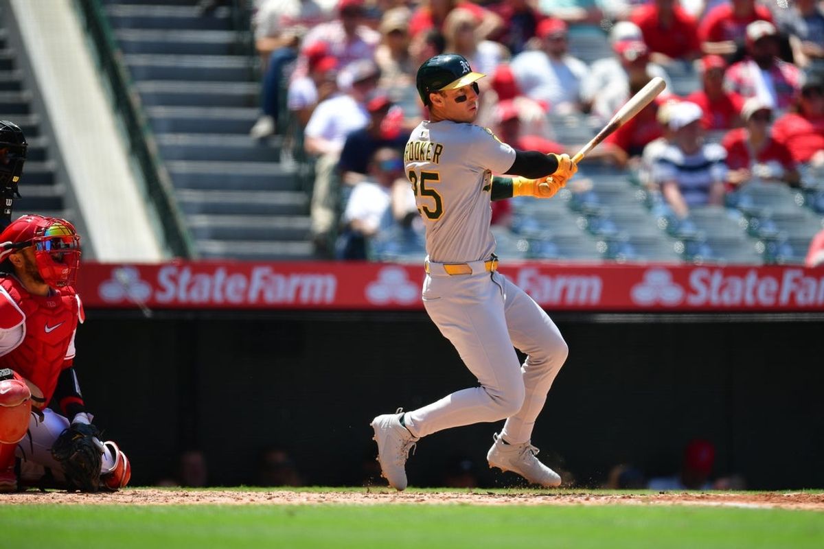 Jun 11, 2025; Anaheim, California, USA; Athletics designated hitter Brent Rooker (25) hits a single against the Los Angeles Angels during the fifth inning at Angel Stadium. Mandatory Credit: Gary A. Vasquez-Imagn Images