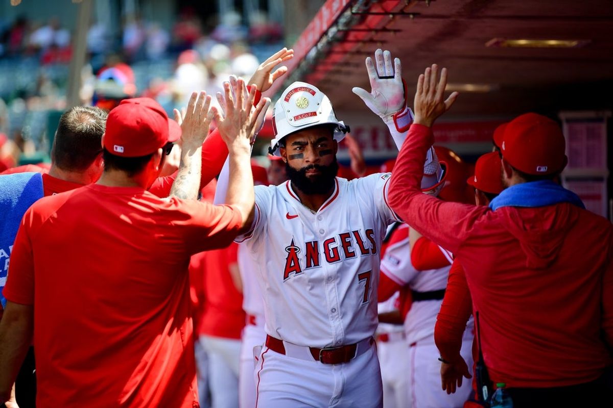Jun 11, 2025; Anaheim, California, USA; Los Angeles Angels center fielder Jo Adell (7) is greeted after hitting a two run home run against the Athletics during the sixth inning at Angel Stadium. Mandatory Credit: Gary A. Vasquez-Imagn Images