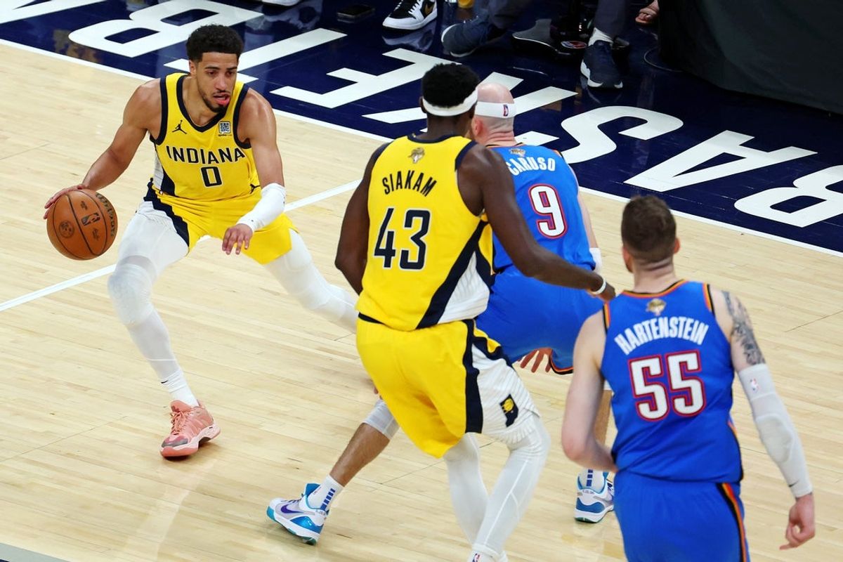 Jun 11, 2025; Indianapolis, Indiana, USA; Indiana Pacers guard Tyrese Haliburton (0) handles the ball against Oklahoma City Thunder guard Alex Caruso (9) during the second quarter in game three of the 2025 NBA Finals at Gainbridge Fieldhouse. Mandatory Credit: Trevor Ruszkowski-Imagn Images