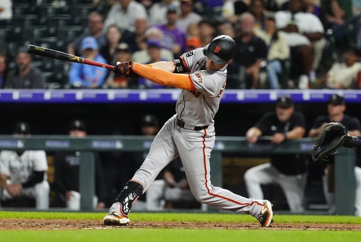 Jun 11, 2025; Denver, Colorado, USA; San Francisco Giants right fielder Mike Yastrzemski (5) hits a two run double in the eighth inning against the Colorado Rockies at Coors Field. Mandatory Credit: Ron Chenoy-Imagn Images