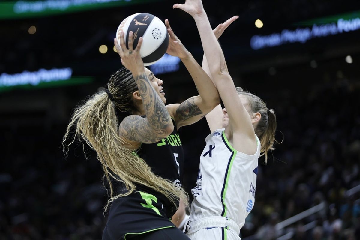 Jun 11, 2025; Seattle, Washington, USA; Seattle Storm forward Gabby Williams (5) drives to the basket against Minnesota Lynx forward Karlie Samuelson (44) during the first half at Climate Pledge Arena. Mandatory Credit: John Froschauer-Imagn Images