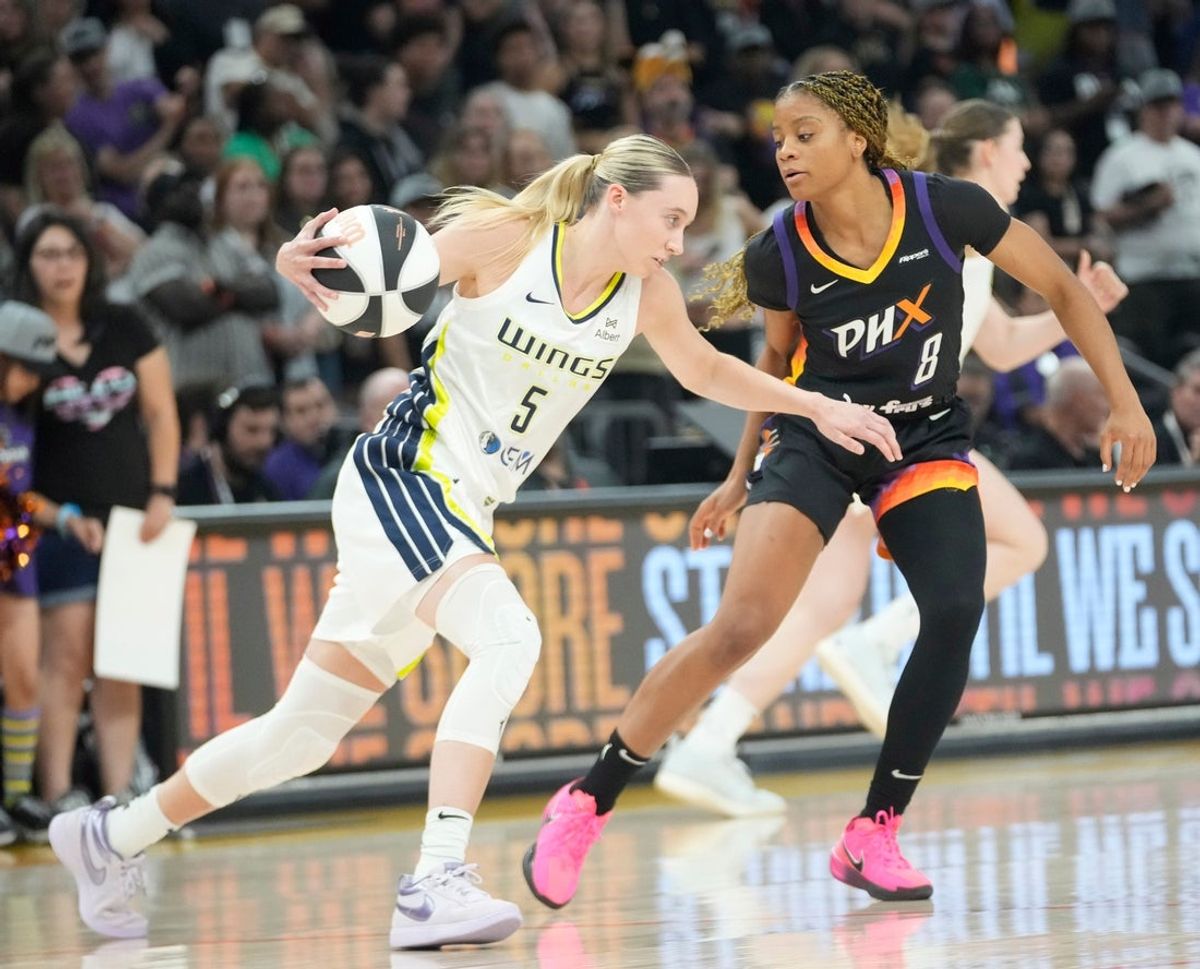 Dallas Wings guard Paige Bueckers (5) is defended by Phoenix Mercury guard Monique Akoa Makani (8) during the first quarter in Phoenix, at PHX Arena on June 11, 2025.
