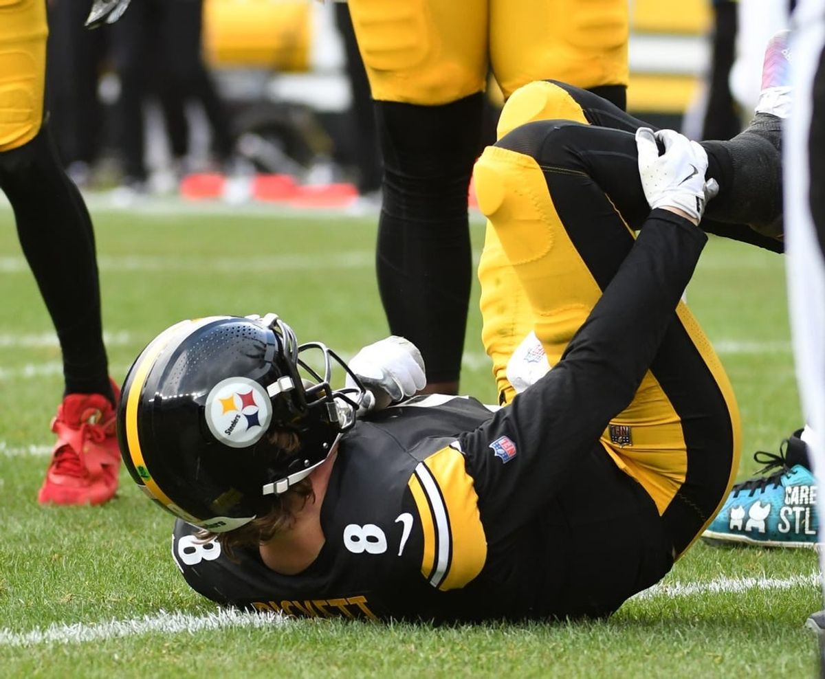Dec 3, 2023; Pittsburgh, Pennsylvania, USA; Pittsburgh Steelers quarterback Kenny Pickett (8) grabs his leg after play against the Arizona Cardinals during the second quarter at Acrisure Stadium. Pickett left the game with an injury.