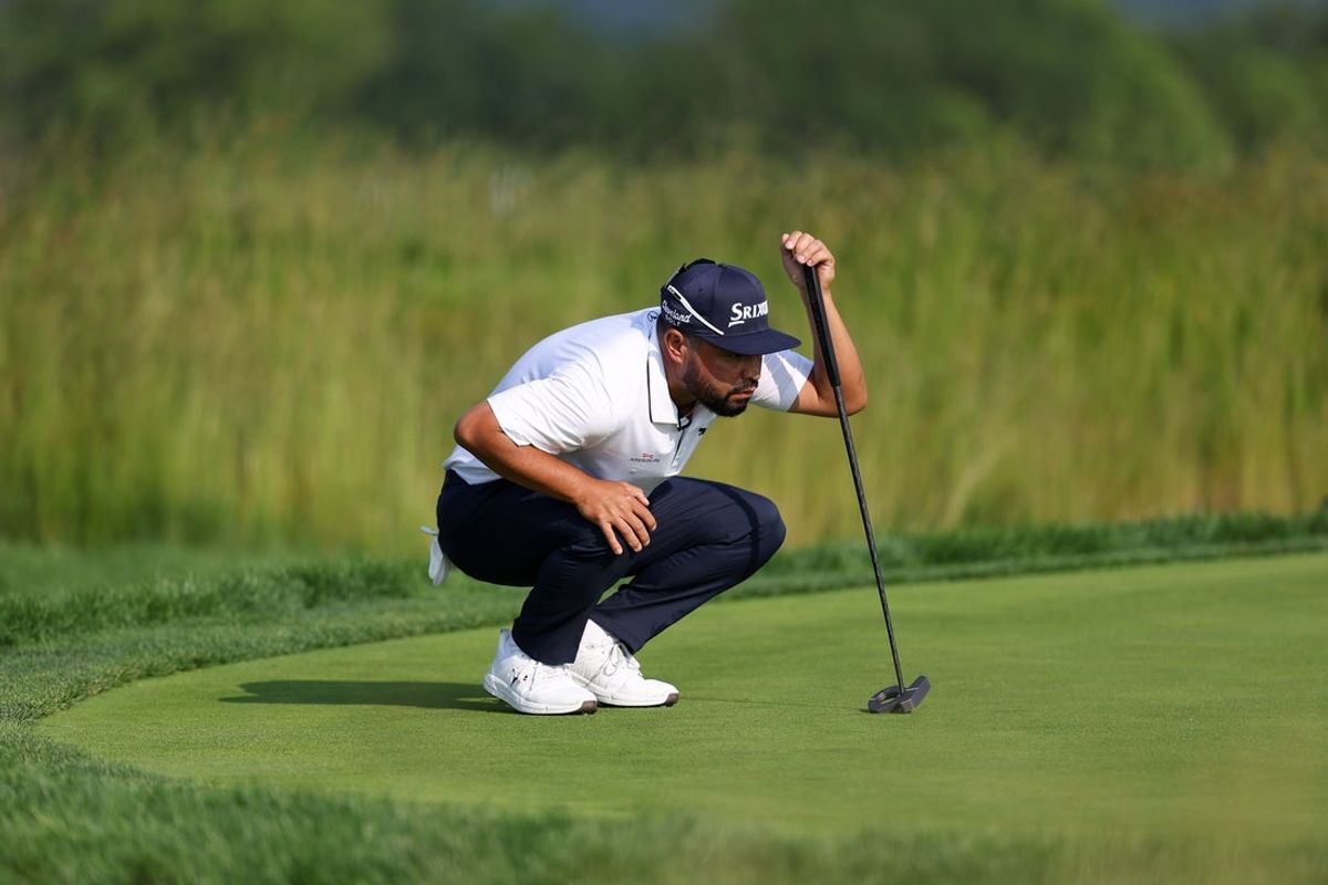 Jun 12, 2025; Oakmont, Pennsylvania, USA; JJ Spaun lines up his putt on the 14th green during the first round of the U.S. Open golf tournament. Mandatory Credit: Bill Streicher-Imagn Images