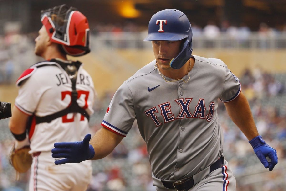 Jun 12, 2025; Minneapolis, Minnesota, USA; Texas Rangers left fielder Wyatt Langford (36) celebrates his three run home run against the Minnesota Twins in the second inning at Target Field. Mandatory Credit: Bruce Kluckhohn-Imagn Images