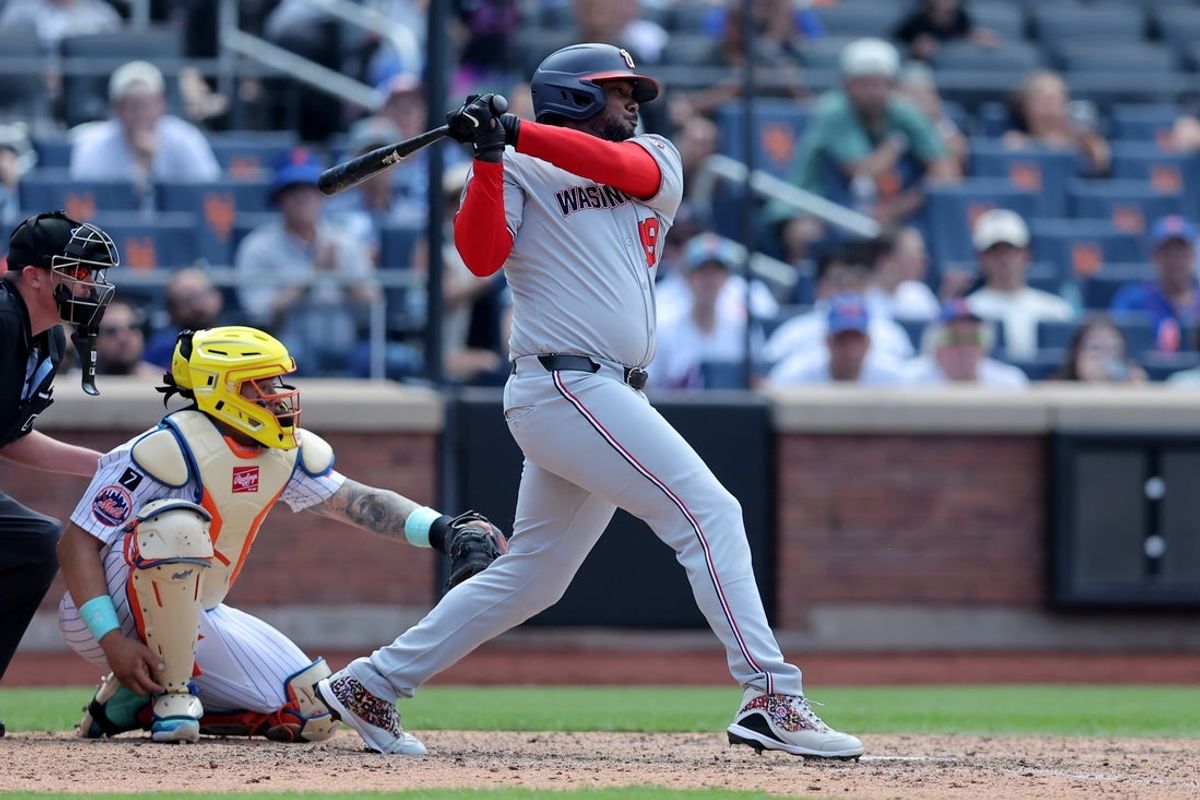 Jun 12, 2025; New York City, New York, USA; Washington Nationals designated hitter Josh Bell (19) follows through on an RBI single against the New York Mets during the ninth inning at Citi Field. Mandatory Credit: Brad Penner-Imagn Images