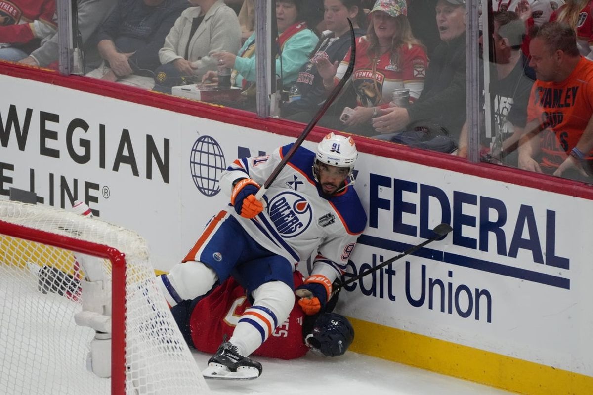 Jun 12, 2025; Sunrise, Florida, USA; Edmonton Oilers left wing Evander Kane (91) boards Florida Panthers defenseman Seth Jones (3) during the first period in game four of the 2025 Stanley Cup Final at Amerant Bank Arena. Mandatory Credit: Jim Rassol-Imagn Images