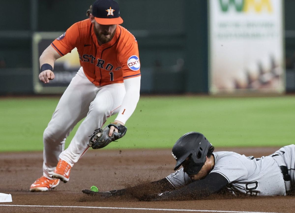 Jun 12, 2025; Houston, Texas, USA; Chicago White Sox third baseman Miguel Vargas (20) slides into third safely as Houston Astros second baseman Brendan Rodgers (1) is late with the tag in the first inning at Daikin Park. Mandatory Credit: Thomas Shea-Imagn Images
